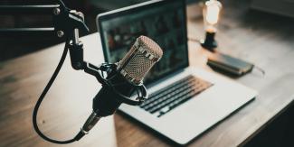 Podcast microphone in front of laptop.
